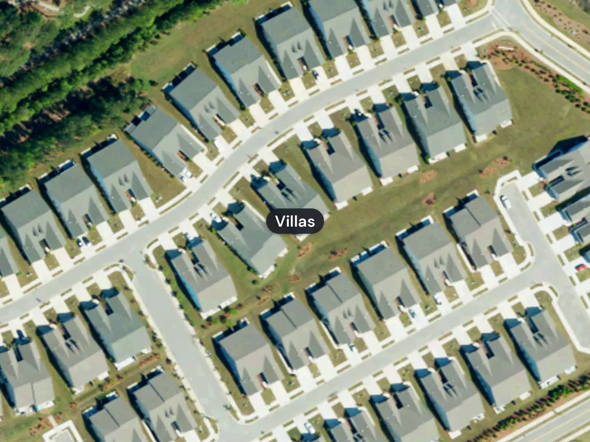 Streets of villas in Del Webb at Grande Dunes, each building two homes joined by a shared wall, seen from above, with the label Villas