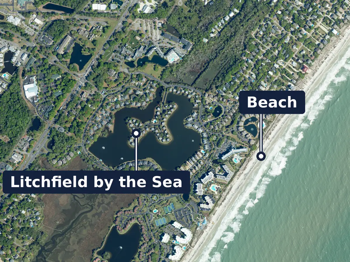 Litchfield by the Sea from above, labelled: homes around a large lake, large buildings and tennis courts near the beach, and the Atlantic Ocean at the right; labels: Litchfield by the Sea and Beach