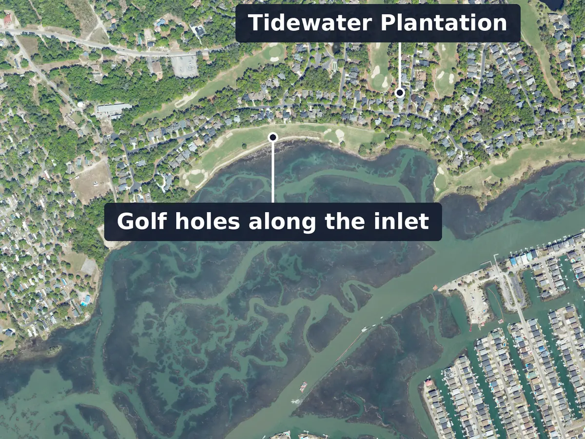 Tidewater Plantation from above, labelled: golf fairways along the tidal water behind Cherry Grove Inlet, houses above them, and canal homes at the lower right; labels: Golf holes along the inlet and Tidewater Plantation