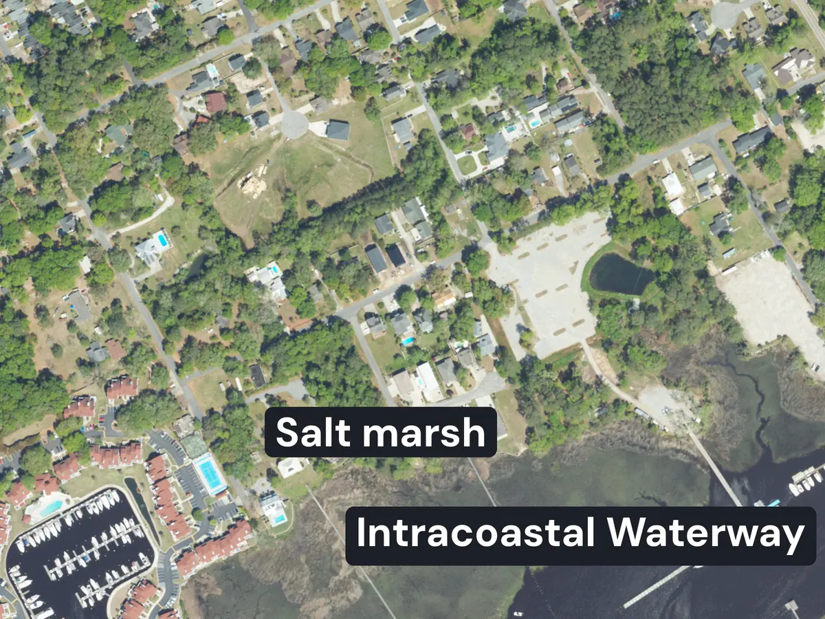 Little River from above: houses on wooded streets, a marina with boat slips at the lower left, docks running across a salt marsh labelled Salt marsh, and dark water labelled Intracoastal Waterway at the lower right